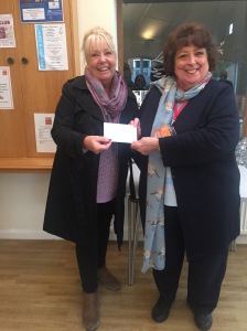 Tina delivering the cheque for £155 raised at the Landen Park Residents' carol Singing in 2019.